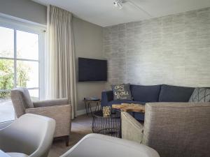 a living room with a couch and two chairs at Apartment with Private Terrace Garden in De Cocksdorp Texel in De Cocksdorp