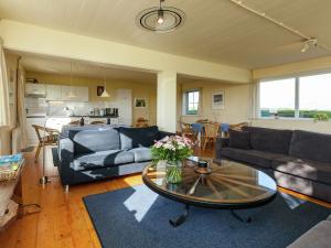 a living room with couches and a coffee table at Peaceful vacation home in Finsterwolde with wide views in Finsterwolde