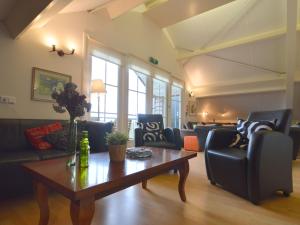 a living room with couches and a coffee table at Luxury Holiday Home In Noordbeemster in Noordbeemster