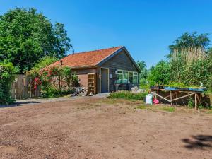 a house with a dirt driveway in front of it at Farmhouse in Eastermar near De Leijen River in Hoogzand