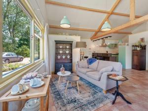 a living room with a couch and a table at Farmhouse in Eastermar near De Leijen River in Hoogzand +32 photos