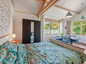 a bedroom with a large bed and a table at Farmhouse in Eastermar near De Leijen River in Hoogzand