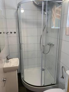 a bathroom with a shower and a toilet and a sink at Choczewski Zakątek in Choczewo +19 photos