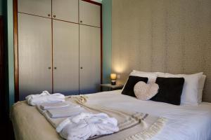 a bedroom with a bed with towels on it at Our Dream Downtown Experience by AnaLodges in Funchal