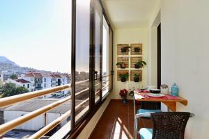 a balcony with a table and chairs and a view at Our Dream Downtown Experience by AnaLodges in Funchal