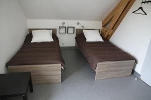 two beds in a small room with a table at Auberge Saint Jacques in Saint-Alban-sur-Limagnole +36 photos