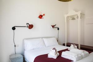 a bedroom with a bed with towels on it at SIGNORA ANGELINA in Polignano a Mare