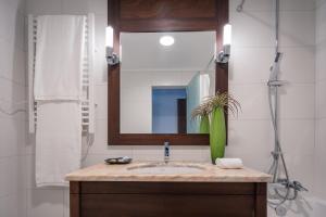 a bathroom with a sink and a mirror at Senhora da Rosa, Tradition & Nature Hotel in Ponta Delgada