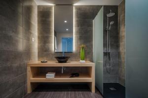 a bathroom with a sink and a shower at Senhora da Rosa, Tradition & Nature Hotel in Ponta Delgada