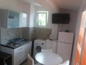 a small kitchen with a washing machine and a sink at Apartments Kurilj in Makarska +92 photos