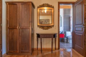 a room with a table and a mirror on the wall at Aggelon Katafygio in Asprangeloi