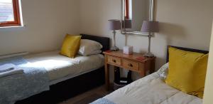 a bedroom with a bed and a desk at Aberfeldy Lodge Guest House in Inverness