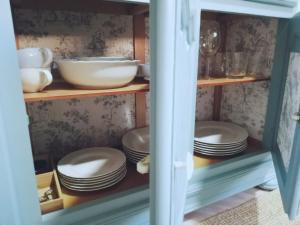 a cabinet filled with plates and bowls and dishes at Alojamiento Migjorn - Apartaments tres Vents in Sóller