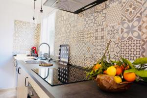 a kitchen with a bowl of fruit on a counter at Alojamiento Migjorn - Apartaments tres Vents in Sóller