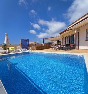 a swimming pool in front of a house at Villa Las Tres J in Málaga