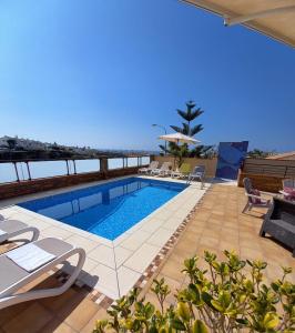 a swimming pool on the roof of a house at Villa Las Tres J in Málaga