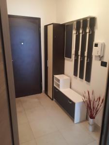 a bathroom with a sink and a black door at Pleasing place in Fažana