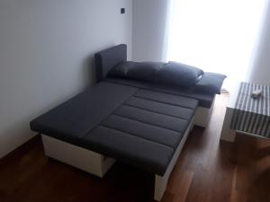 a futon bed in a room with a window at Pleasing place in Fažana
