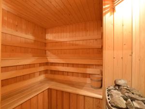 a wooden sauna with a bucket in it at Cosy Holiday Home in Rendeux in La-Roche-en-Ardenne