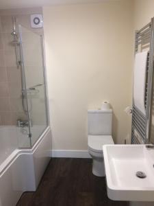 a bathroom with a toilet and a shower and a sink at Hilltop Cottage in Dursley +9 photos