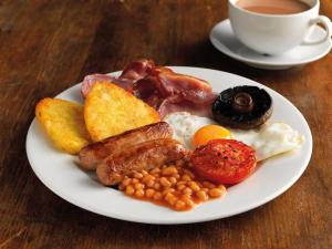 a plate of breakfast food with a cup of coffee at Black Lion in Scarborough