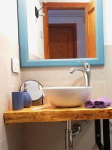 a bathroom counter with a sink and a mirror at Alojamiento Ponent - Apartaments tres Vents in Sóller