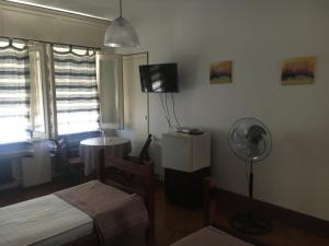 a room with a room with two beds and a fan at Petit in Fray Bentos