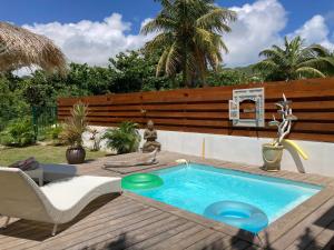 a swimming pool on a deck with a table and chairs at Life is Good in SXM in Saint Martin