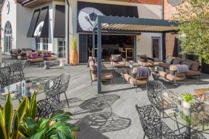 a patio with couches and tables and chairs at Crowne Plaza Solihull, an IHG Hotel in Solihull