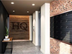 a hallway with a wooden door and a brick wall at City Apartments - Hudson Quarter in York