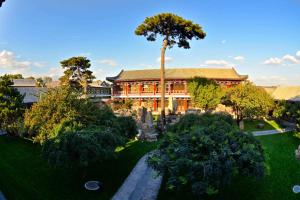 an aerial view of a building with a palm tree at Chengde Imperial Mountain Resort in Chengde