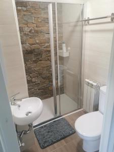 a bathroom with a shower and a toilet and a sink at Casa rural pepe in Trias