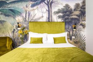 a bedroom with a large bed with a tropical wallpaper at The Vista Rooms & Terrace in Rome