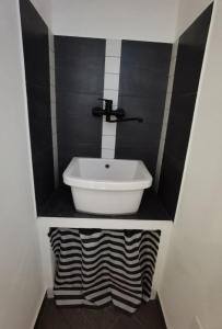 a bathroom with a white sink in a room at appartamento dei colori anticaglie in Punta Secca