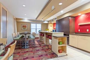 a large kitchen with a bar and a dining room at Extended Stay America Suites - Richmond - Glen Allen - Short Pump in Glen Allen