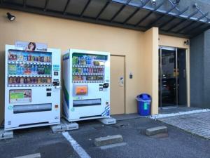 two machines are parked in front of a building at Plaza Arakawaoki - Vacation STAY 24681v in Tsuchiura