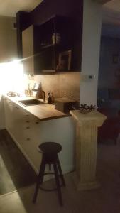 a kitchen with a stool and a sink and a counter at Apartament Margaret Twardogóra in Twardogóra