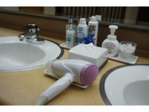 a hair brush sitting on a bathroom counter next to a sink at Plaza Arakawaoki - Vacation STAY 24686v in Tsuchiura +36 photos