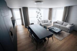 a living room with a table and a couch at Andermatt Alpine Apartments in Andermatt
