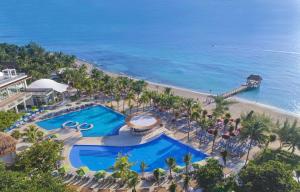 an aerial view of a resort with a pool and the ocean at The Fives Beach Hotel & Residences - All Senses Inclusive in Playa del Carmen