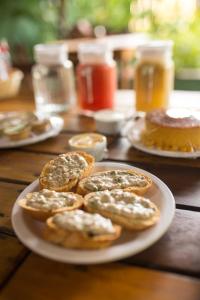 a plate of pastries on a wooden table at Pousada Sossego Boipeba in Ilha de Boipeba +28 photos