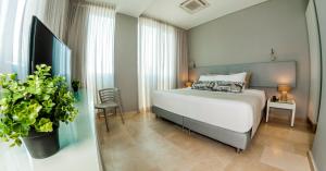 Ένα ή περισσότερα κρεβάτια σε δωμάτιο στο Oz Hotel Cartagena