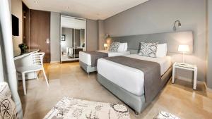 Ένα ή περισσότερα κρεβάτια σε δωμάτιο στο Oz Hotel Cartagena