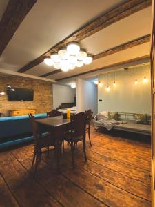 a dining room with a table and chairs and a bed at Penzion U Fridy Apartman 1 in Loket