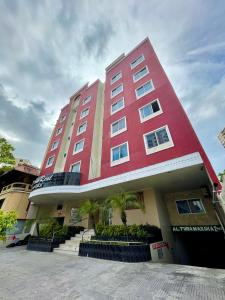 a large red building with stairs in front of it at Hospedaje Camino Real in Panama City