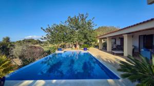 a swimming pool in the backyard of a house at Casa Ibicenca Con Piscina Privada in San Jose