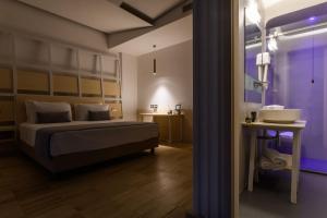 a bedroom with a bed and a sink in a room at Hangar Hotel in Teverola +41 photos
