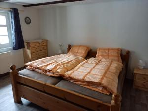 a bedroom with a bed with a blanket on it at Wollröder Krug in Guxhagen +19 photos