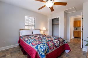 a bedroom with a bed and a ceiling fan at The Cottages in Etlan