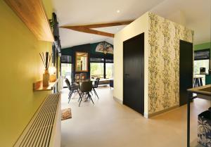 a hallway with a door leading to a dining room at ZEN-bungalow NO 1 met Sauna en hottub in Rheezerveen